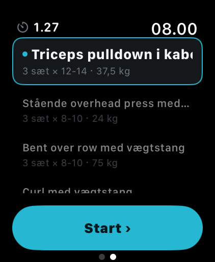 Øvelseslisten i Musklr på Apple Watch mellem to øvelser: Triceps pulldown i kabeltårn med V-håndtag er valgt, 3 sæt med 12 til 14 reps på 37,5 kg, med knappen Start